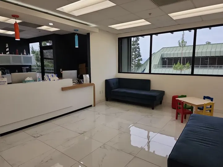 A bright, calm waiting room with a play table for little ones — Lighthouse Pediatrics, Torrance