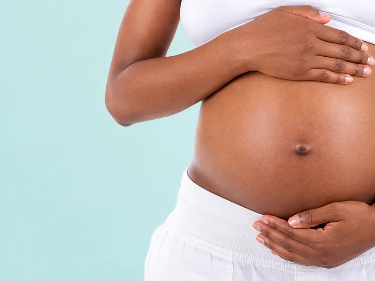 Expecting mother holding her belly